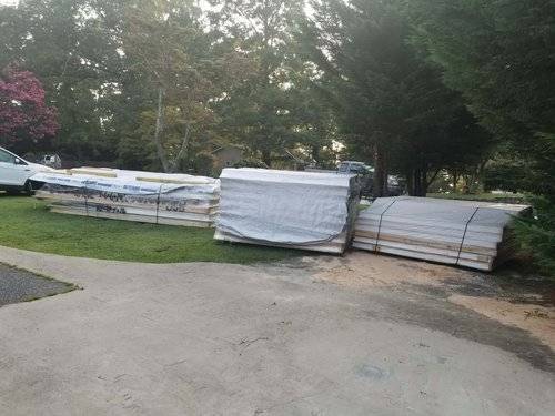 cottage kit home build site with SIP panels unloaded and stacked