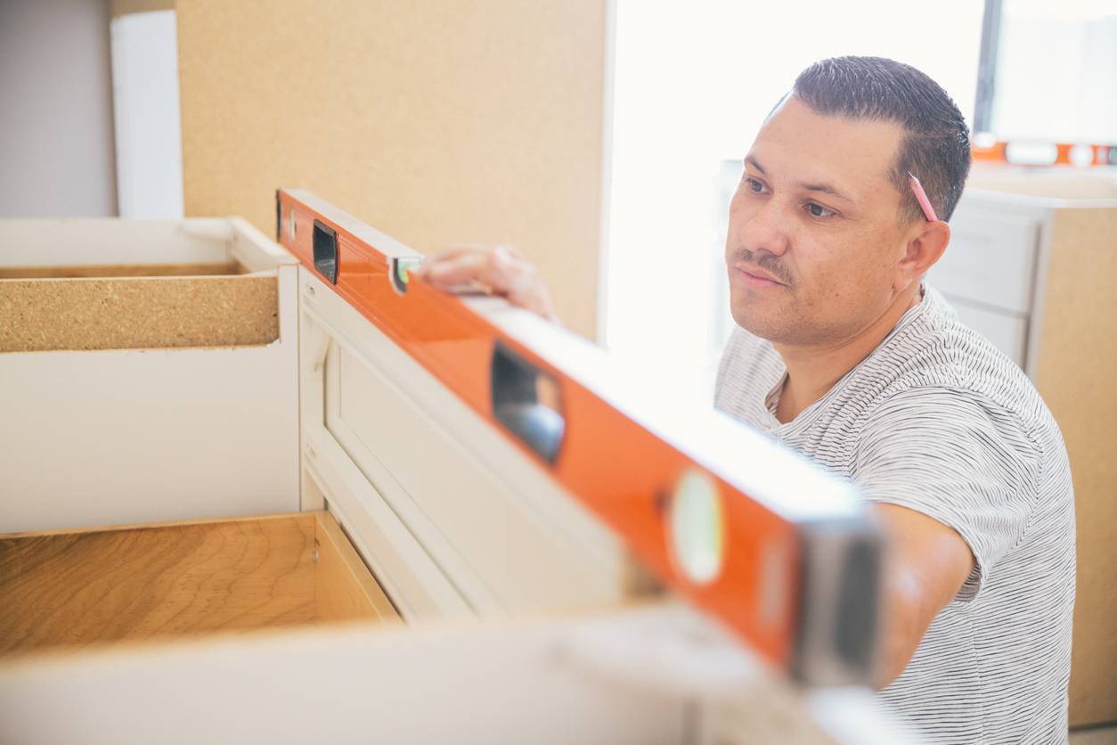 Image of a carpenter at work with a level