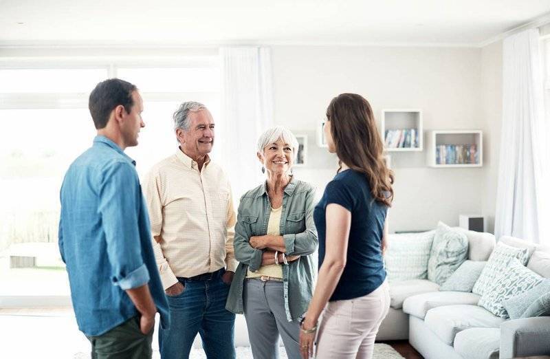 Young couple in living room with in-laws