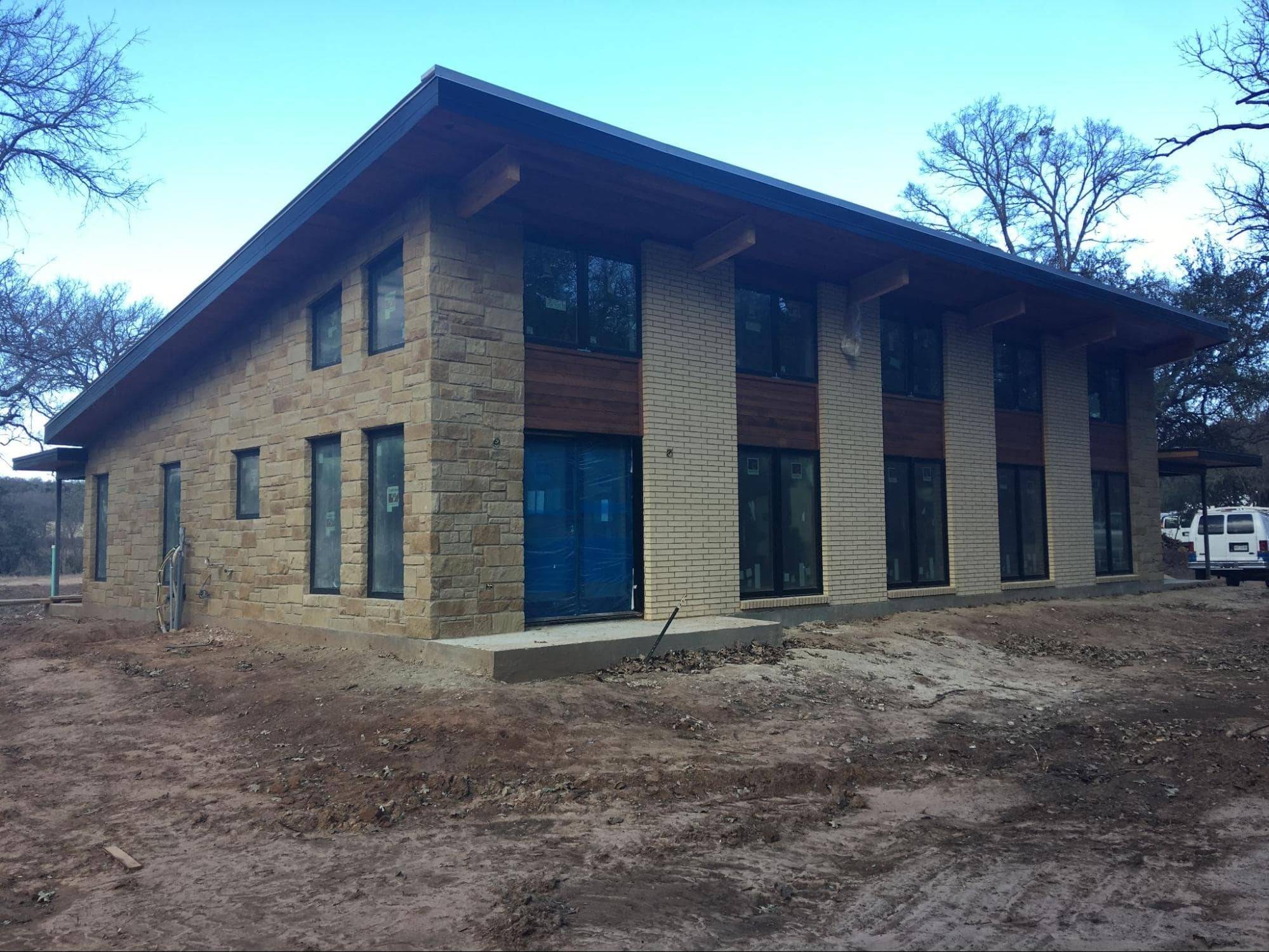 MSH 20180208 texas modern custom stone brick outdoors finished yellow stonework left side front view PX min