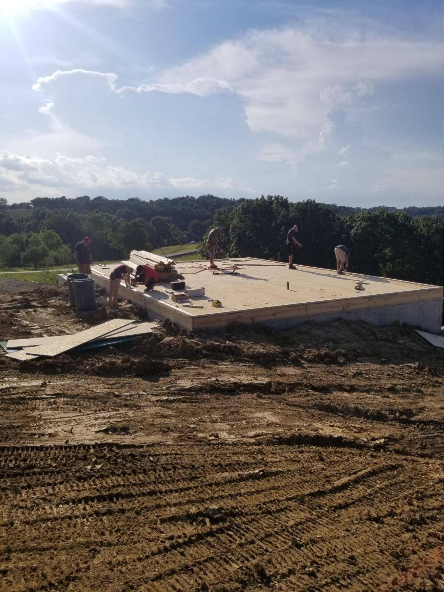 MSH 20190610 outdoors Summer foundation construction workers pallet equipment Wide Shot PX min