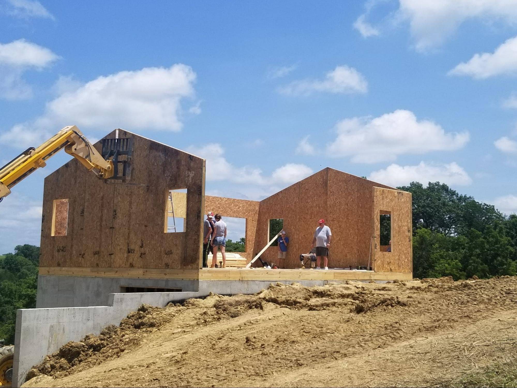 MSH 20190610 outdoors construction WIP SI Ps foundation No Roof equipment workers Left Side View PX min