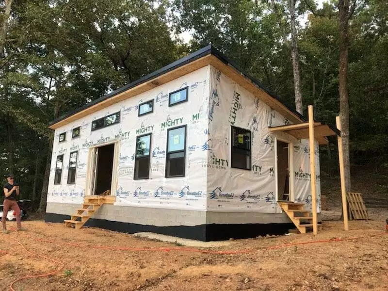 MSH 20191023 outdoors construction waterproofing workers foundation front side right view PX