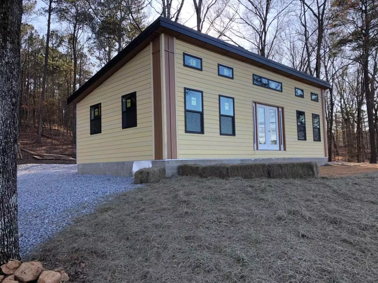 MSH 20200214 Winter outdoors finished yellow paneling gravel front side left view PX
