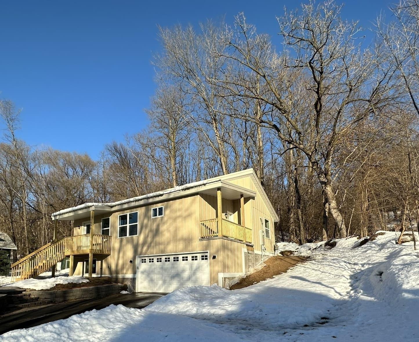 contemporary Mighty Small Homes SIP house in a snowy Minnesota winter setting with trees in the background