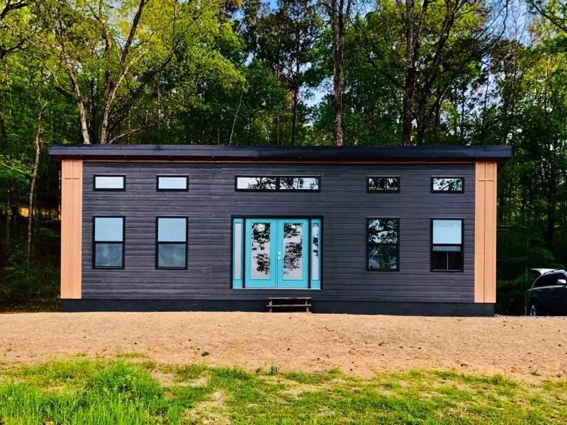 MSH 20220423 outdoors finished black paneling blue door Spring front side view PX