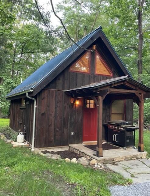 MSH 20230707 rural suburb New York City outdoors finished brown paneling blue roof front view lantern red door PX min