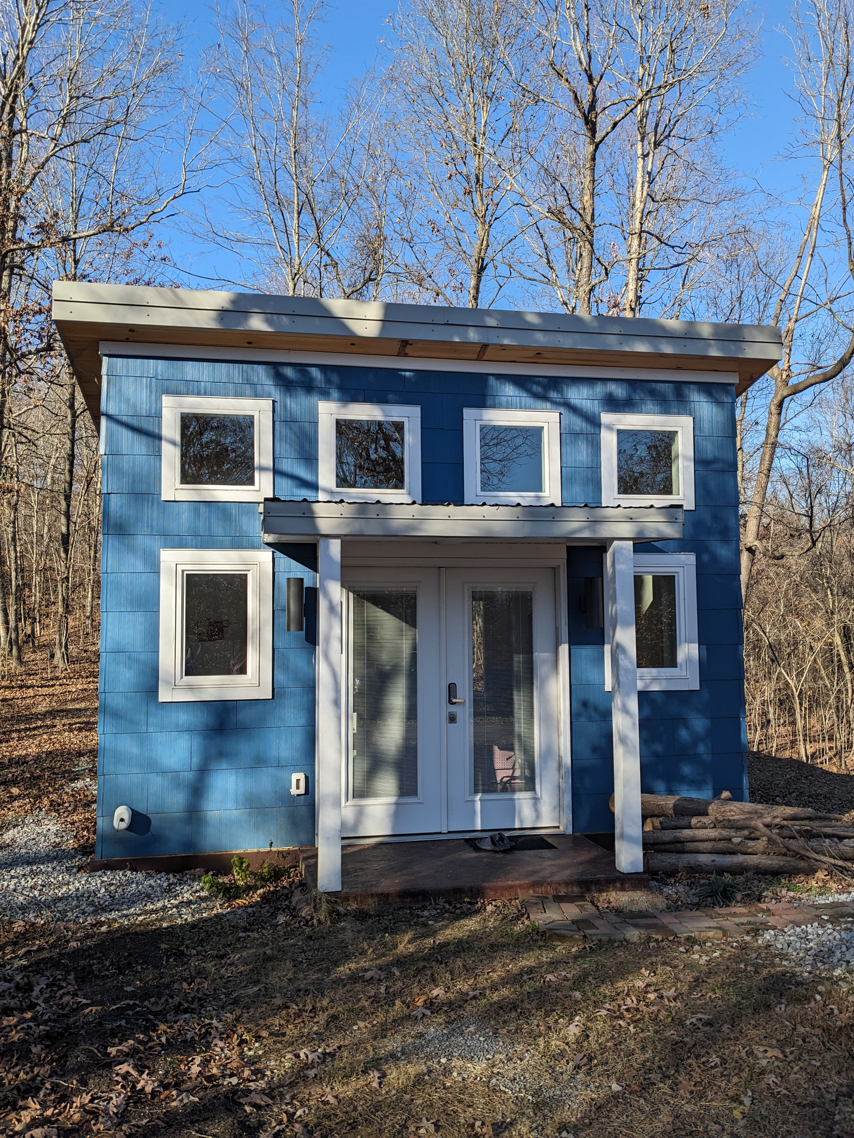 MSH 20231215 customer build modern outdoors finished blue siding white trim winter front side close up view PX