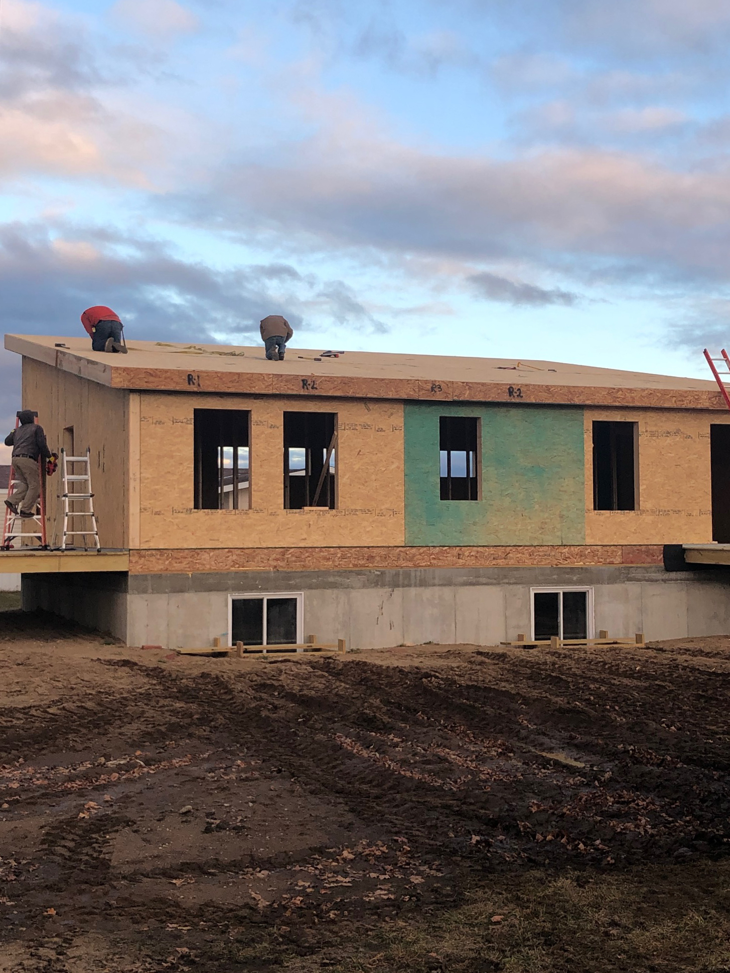 Front view of Michigan Modern customer build with final roof panel being installed