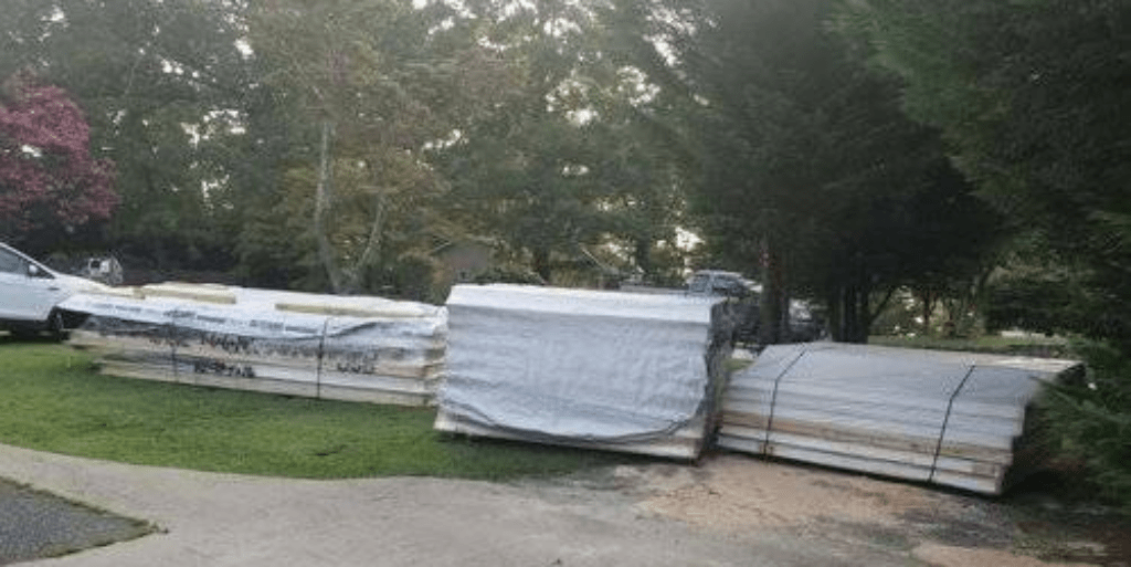 Photo showing delivery of panel and building materials