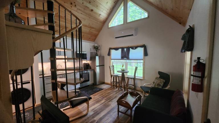 compact SIP home interior with loft, vaulted wood ceilings, and open-concept layout demonstrating flexible small-home design beyond transport-limited modular sections