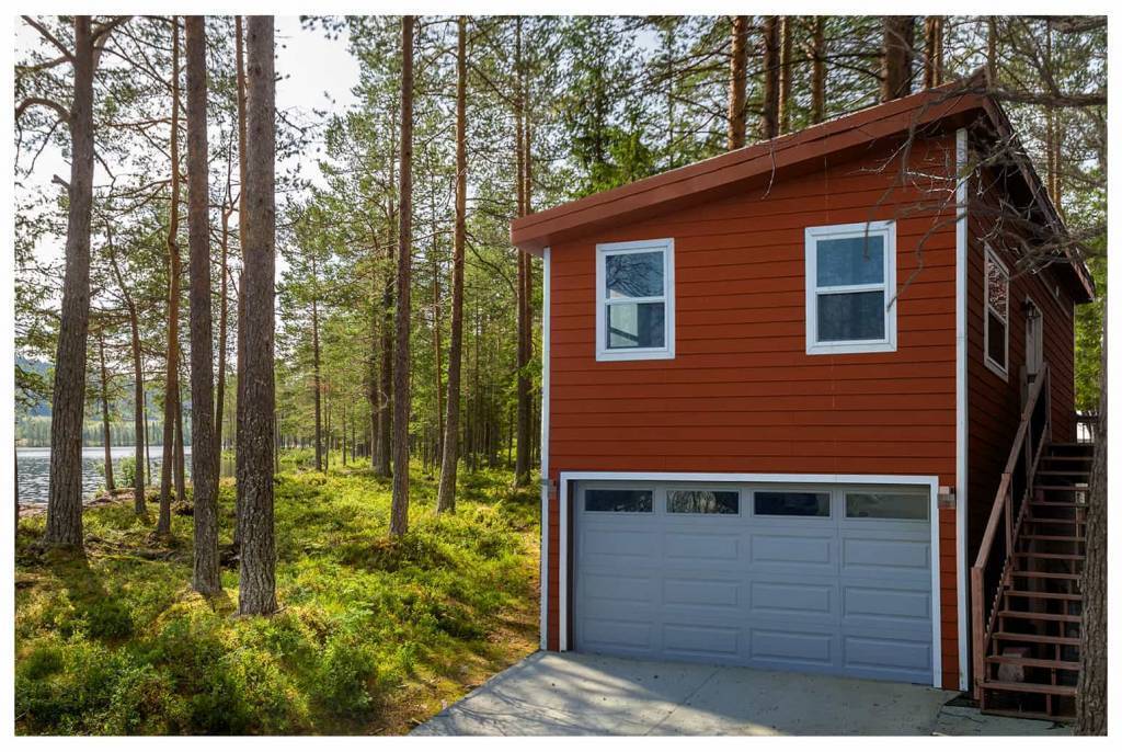 carriage house with garage in the woods by a lake