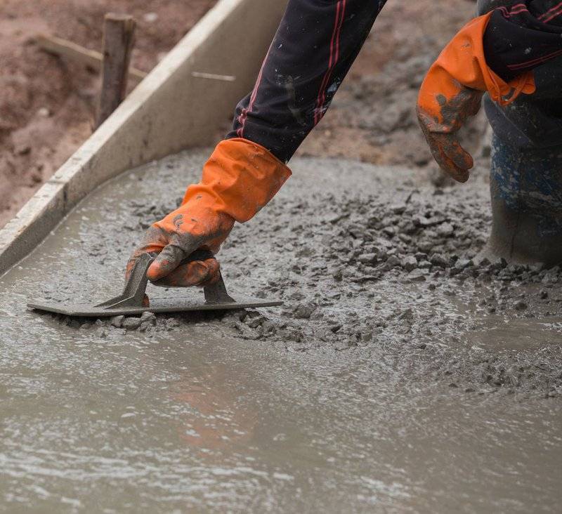 photo of someone smoothing a wet concrete slab foundation