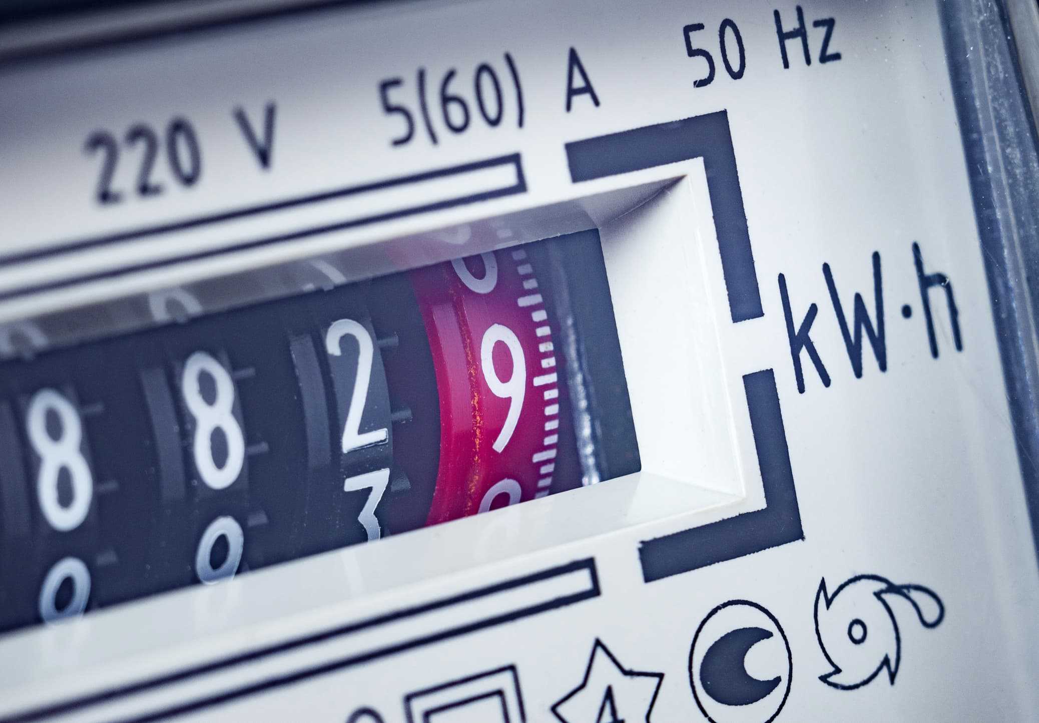 close‑up of an analog electricity meter showing kilowatt‑hour readings and technical marking