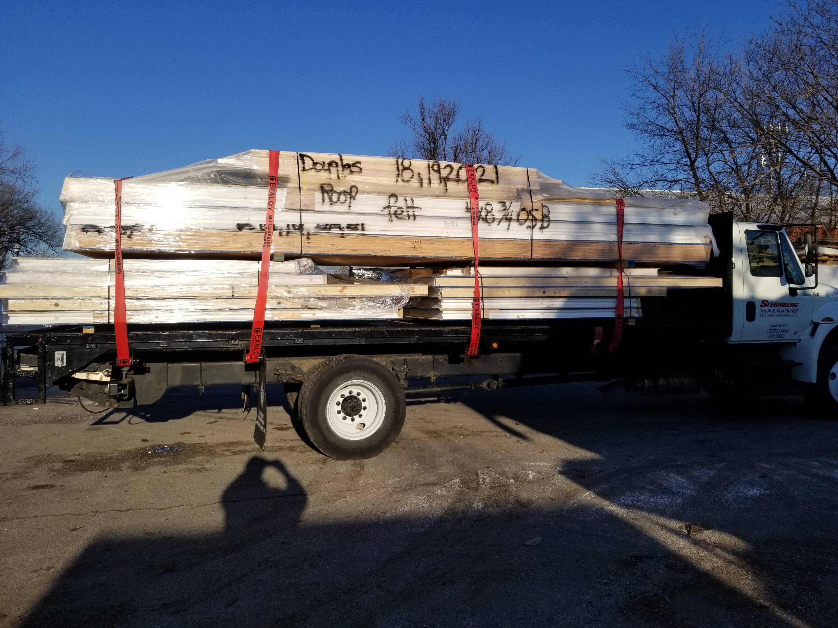House kit build site truck delivering panels sips