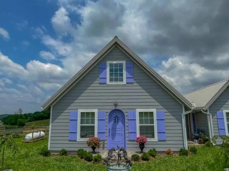 example of cotage model with gray siding and lavender shutters and doors built in Tennessee