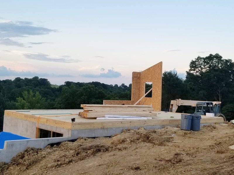 Kit Home Build Site with First Panels Up On Foundation