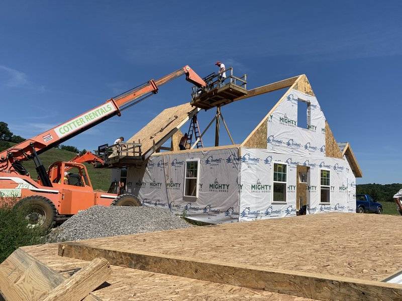 kit-home-construction-example-roof-panels-hydraulic-boom.JPGkit home construction site with roof panels lifted by hydraulic boom