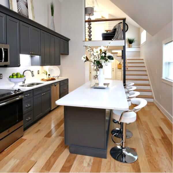 interior of cottage style sips home with stairs leading to a loft in the background