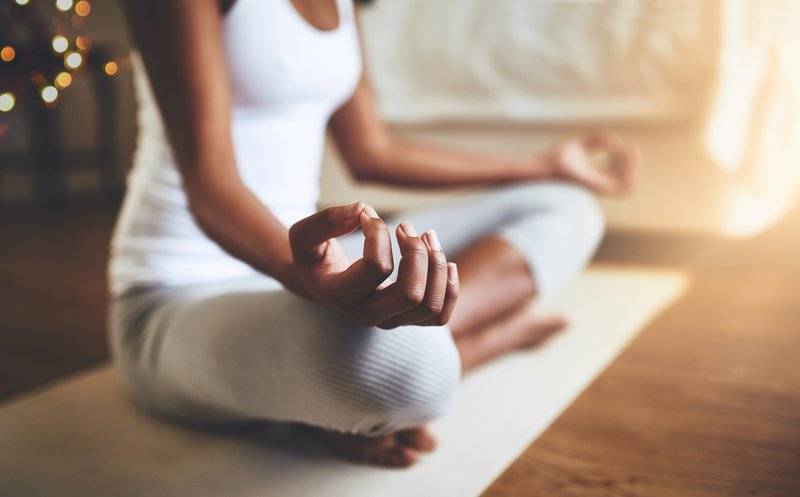 Woman practicing meditation indoors