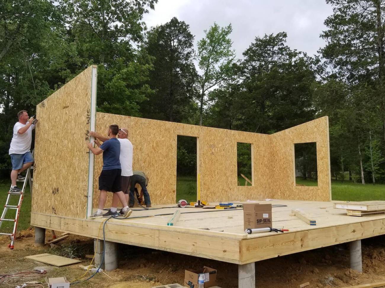 Workers installing a wall panel