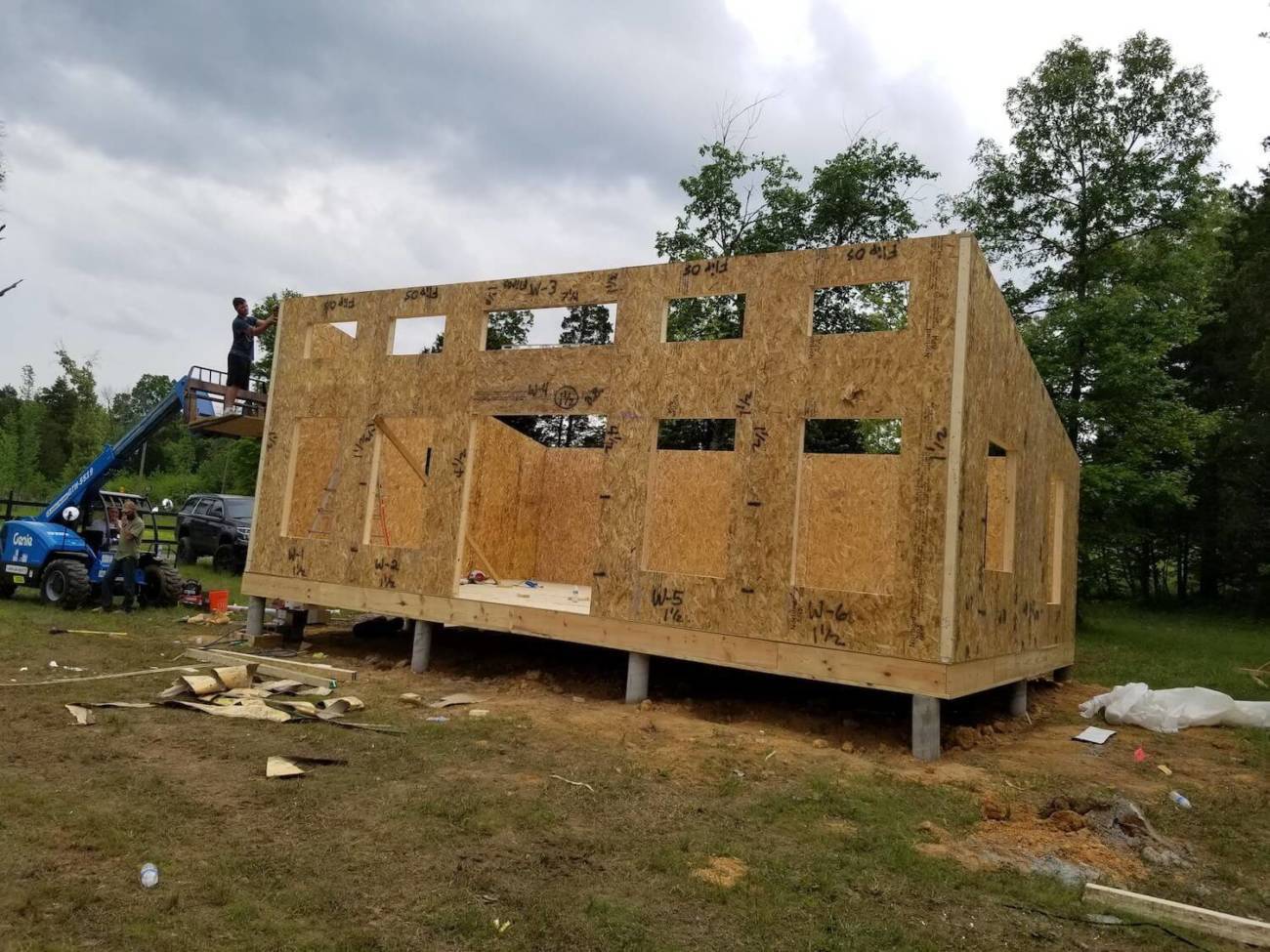 Photo of workman finishing installation of the final wall panel