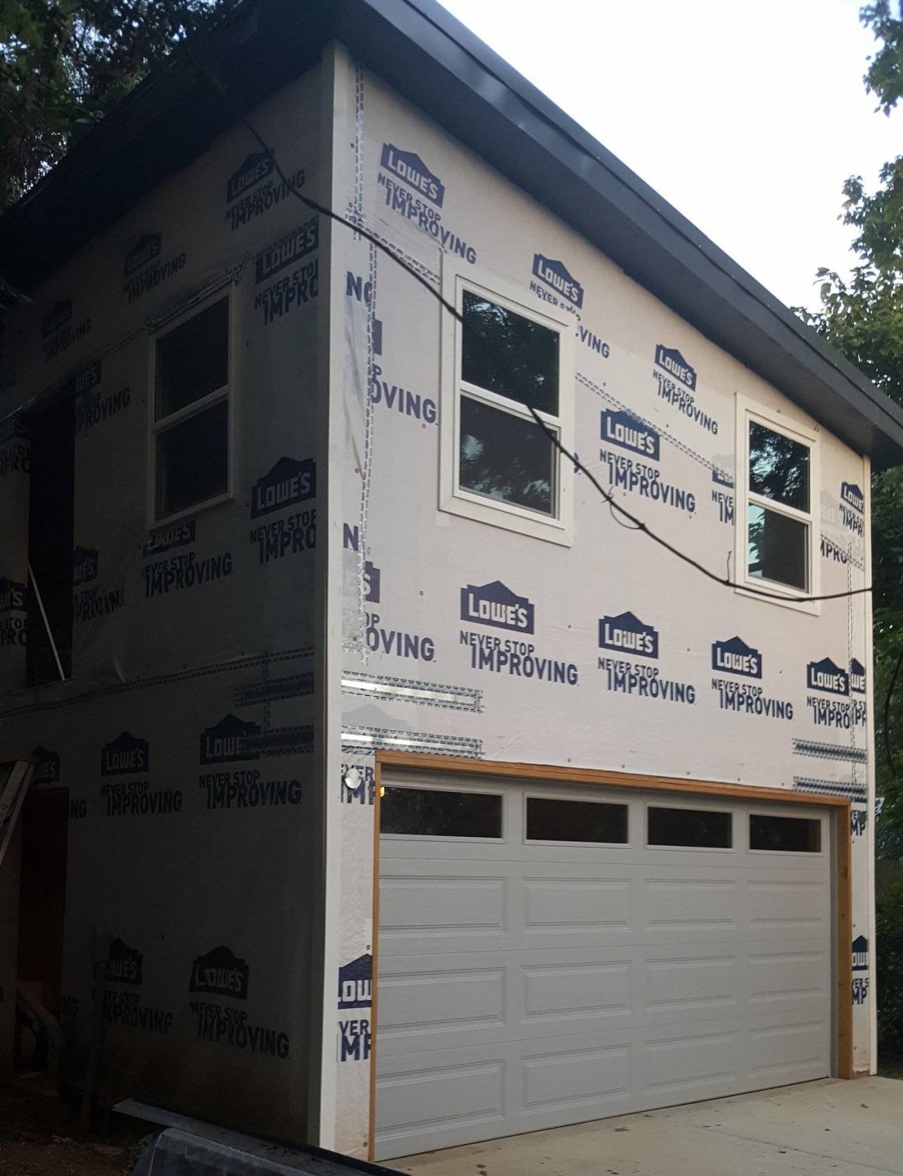 Angled view of a Carriage House with house wrap