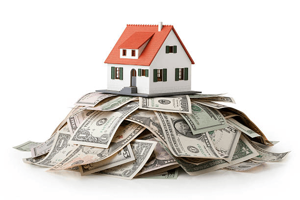Image of a house sitting on top of a pile of cash