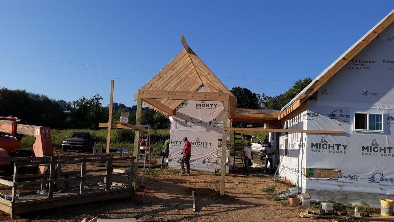 A rear-view photo of an MSH Cottage and connected smokehouse under construction