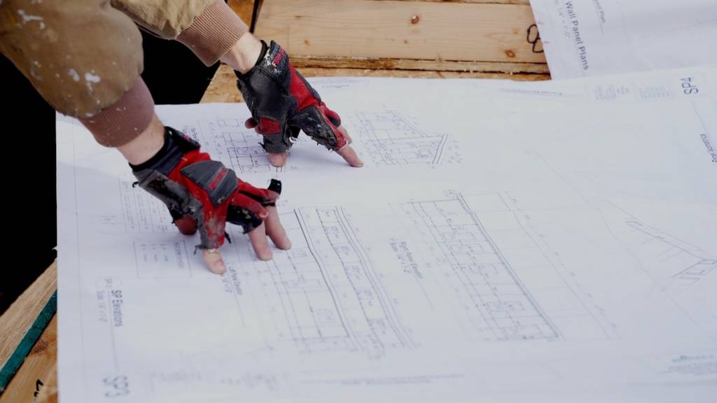 Worker looking at plans