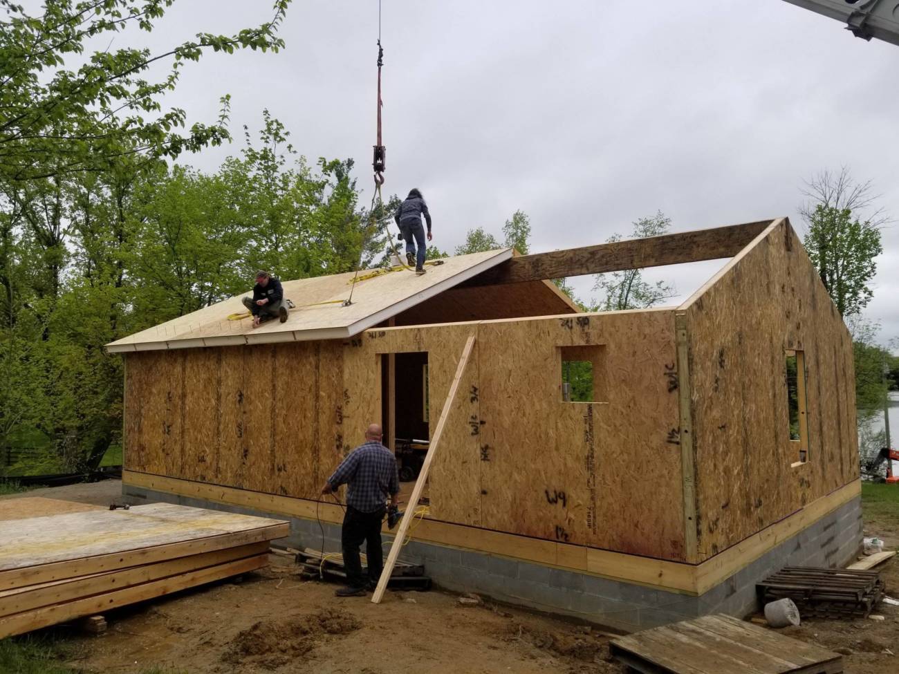 Photo of workers installing the roof of a Ranch kit
