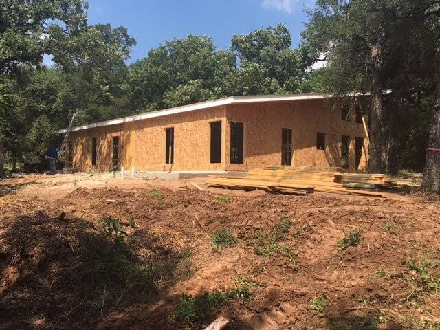 Photo of a rear-right view of a custom modern under roof