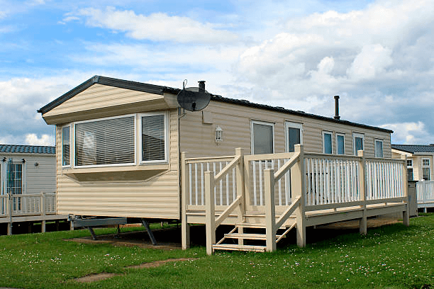 manufactured trailer home on a lot with an added deck