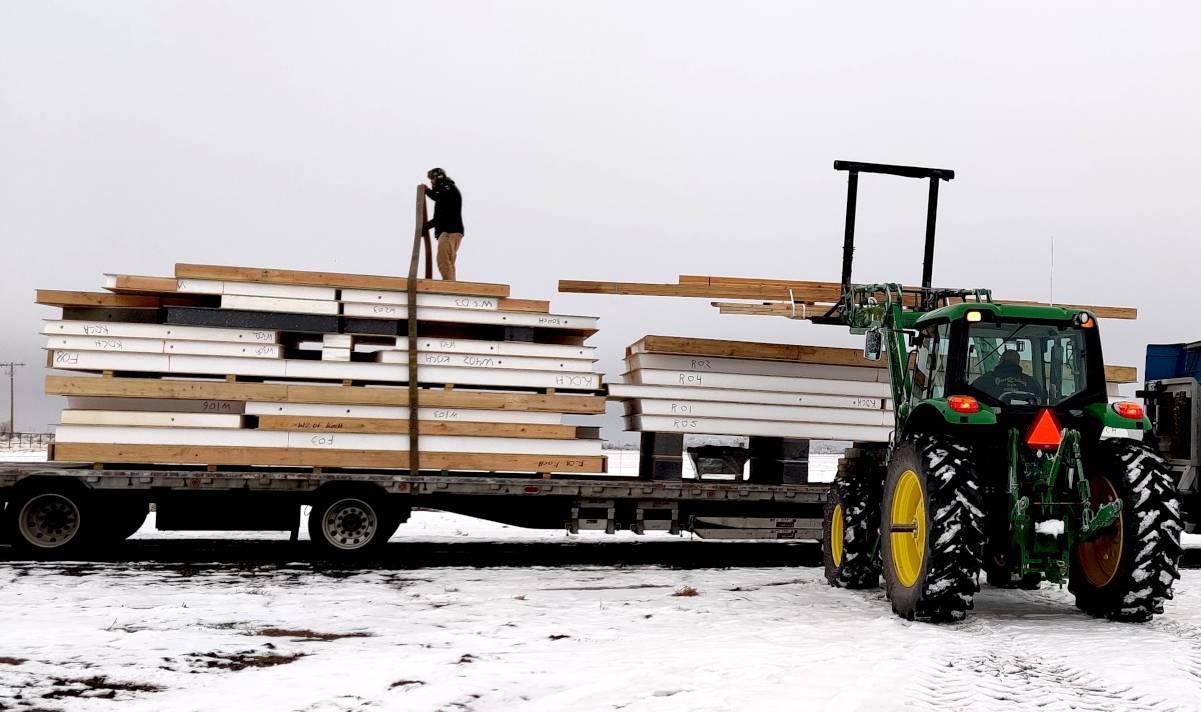Image of a home kit being off-loaded from the semi trailer