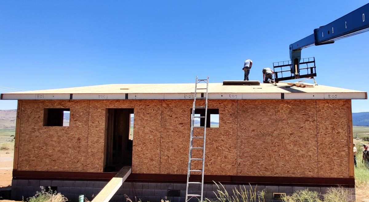 Image of a crew at work installing roof panels