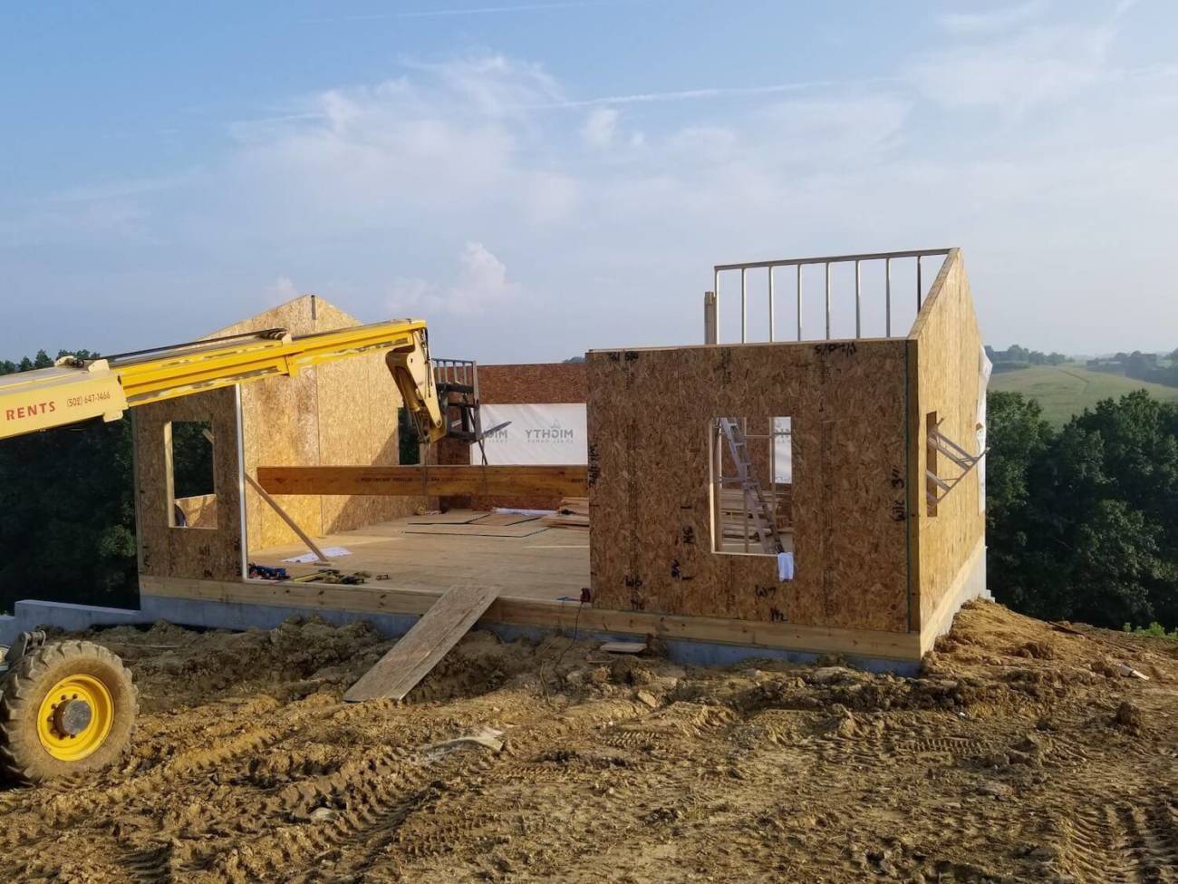 Image of roof beam being set with a crane
