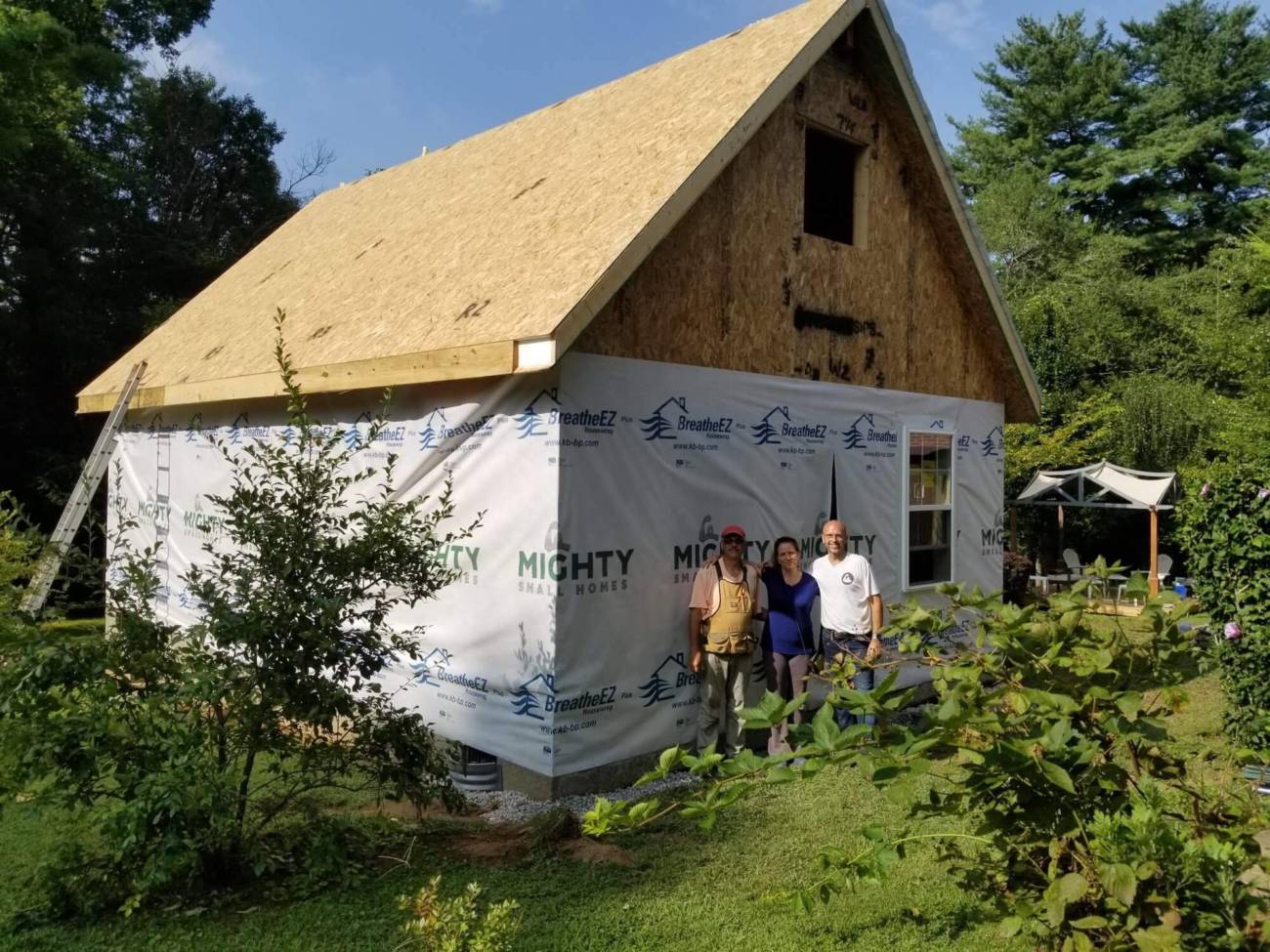 Homeowners pause for a photo as their Cottage nears completion