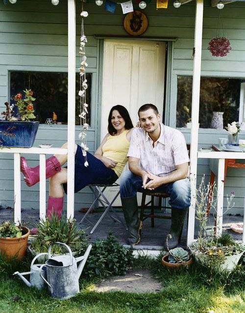 Couple in front of small home