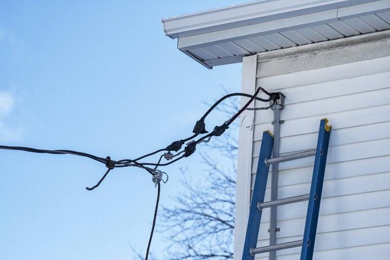 photo of electricity line connecting to a house