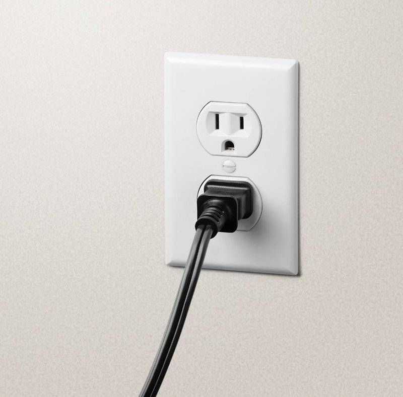 photo of an electrical outlet with appliance plugged in