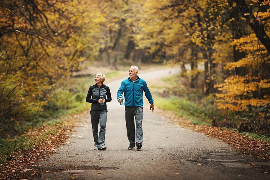 Photo of retirees walking on an autumn day