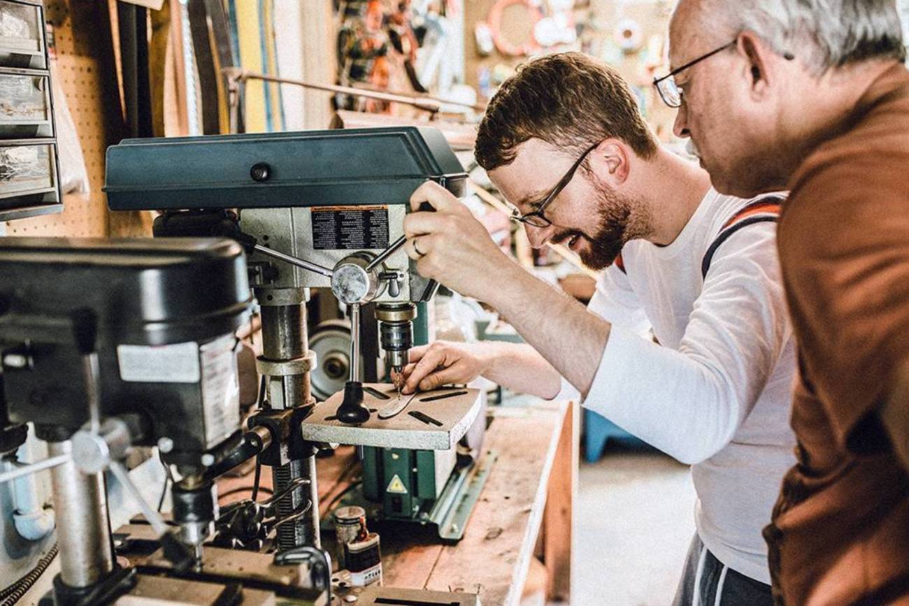 Image of a man working with a drill press